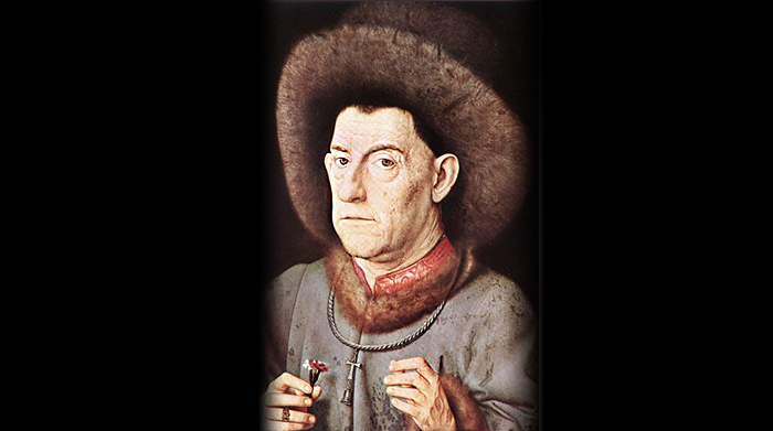 Medieval painting of a man wearing a tau-and-bell pendant.